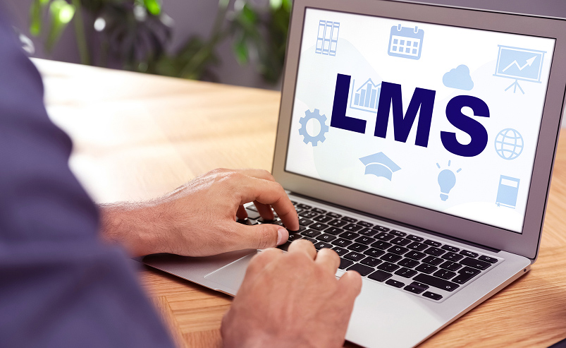 Illustration of a user accessing a Learning Management System (LMS) platform on a computer to manage and follow online training courses